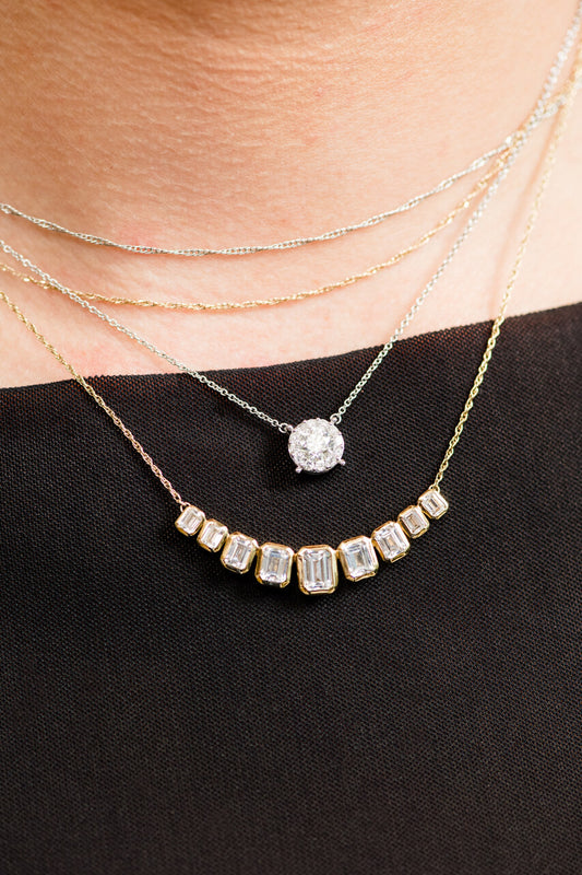 On figure 14K yellow gold amorati diamonds emery emerald cut necklace layered with Lumin Cushion Diamond Pendant Necklace.