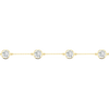 A close-up side view of a 14K yellow gold bracelet, showing a series of bezel-set diamonds connected by a delicate chain.