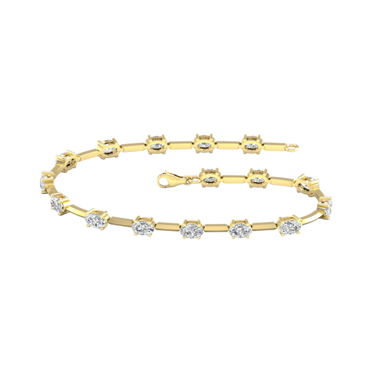 A full top-down view of a 14K yellow gold tennis bracelet, coiled to show the continuous line of square-cut diamonds.