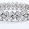 Close-up detail of the Amorati Signature 17-Carat Diamond Tennis Bracelet in white gold, featuring alternating pear-cut diamond floral clusters and square-cut diamonds.