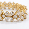 Close-up detail of the Amorati Signature 17-Carat Diamond Tennis Bracelet in yellow gold, featuring alternating pear-cut diamond floral clusters and square-cut diamonds.