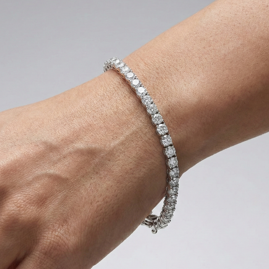 A full top-down view of a 14K white gold tennis bracelet, coiled to show the seamless, continuous line of round diamonds on wrist.