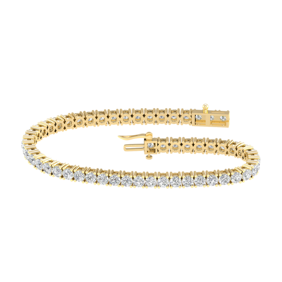 A full top-down view of a 14K yellow gold tennis bracelet, coiled to show the seamless, continuous line of round diamonds.
