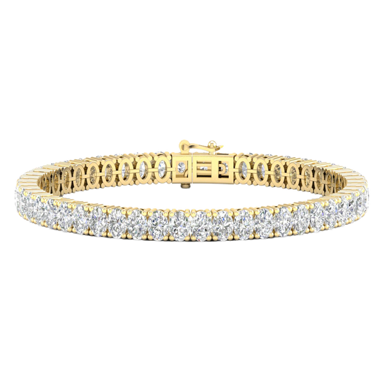 A close-up, top-down view of a lavish 14K yellow gold tennis bracelet featuring two continuous rows of brilliant-cut diamonds set in a four-prong or shared-prong style.