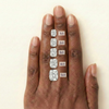 On-hand comparison of cushion cut diamonds from 1 carat, 2 carat, 3 carat, 4 carat, 5 carat.