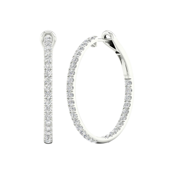 An angled view of a pair of 14K white gold large hoop earrings, highlighting the all-around sparkle from the continuous line of diamonds.
