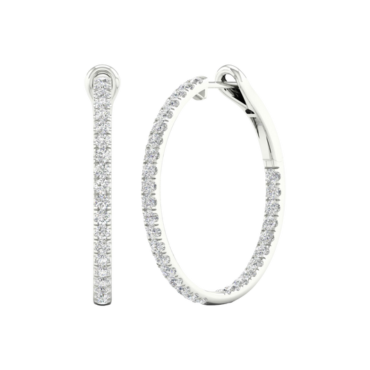 An angled view of a pair of 14K white gold large hoop earrings, highlighting the all-around sparkle from the continuous line of diamonds.