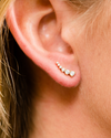 Amorati Diamonds 14K white gold delicate diamond climber earring with a line of graduated pavé diamonds, shown on a model.