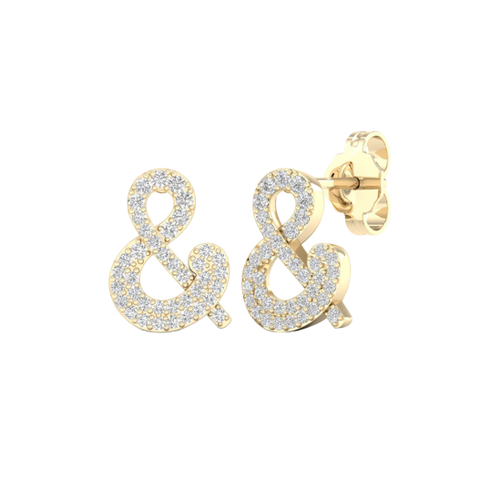 An angled view of a pair of 14K yellow gold stud earrings, showcasing the sparkling ampersand shape.