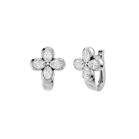 Angled view of white gold floral diamond huggie earrings highlighting the dimensional flower motif, diamond sparkle, and polished metal finish.