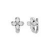 Angled view of white gold floral diamond huggie earrings highlighting the dimensional flower motif, diamond sparkle, and polished metal finish.