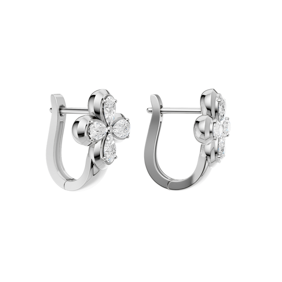 Back view of white-gold floral diamond huggie earrings, showcasing smooth, polished metal, a hinge mechanism, and clean construction.