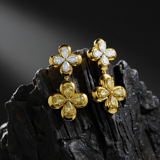 Celebrate moments of grandeur with these drop earrings featuring white and yellow diamond flowers resting on a dark, jagged rock.