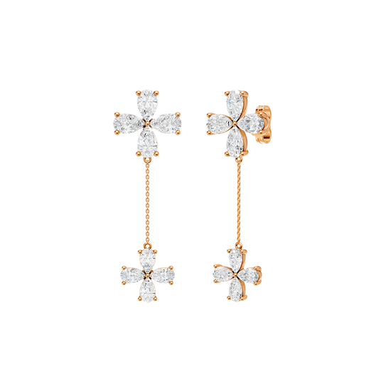 Angled view of rose gold floral diamond drop earrings highlighting warm gold tones, dimensional flower detailing, and diamond sparkle.