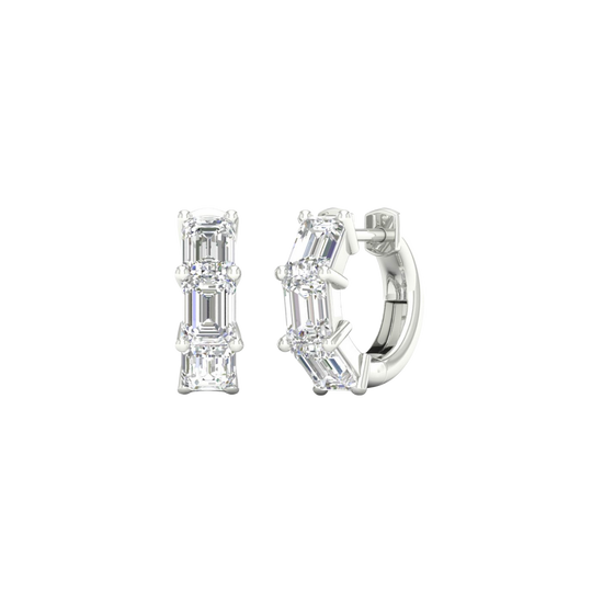 An angled view of a pair of 14K white gold huggie hoops, showcasing the linear design of the diamonds.