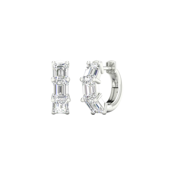 An angled view of a pair of 14K white gold huggie hoops, showcasing the linear design of the diamonds.