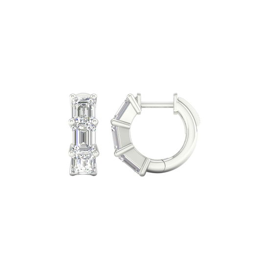 A side profile of a 14K white gold huggie hoop, showing the three stacked baguette diamonds.