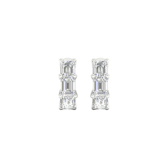 A close-up view of a 14K white gold huggie hoop earring with three vertically stacked rectangular diamonds.