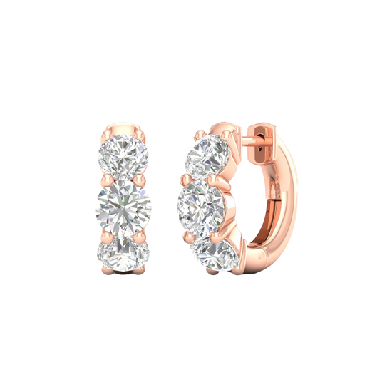 An angled view of a pair of 14K rose gold huggie hoops, highlighting the wide, double-row design.