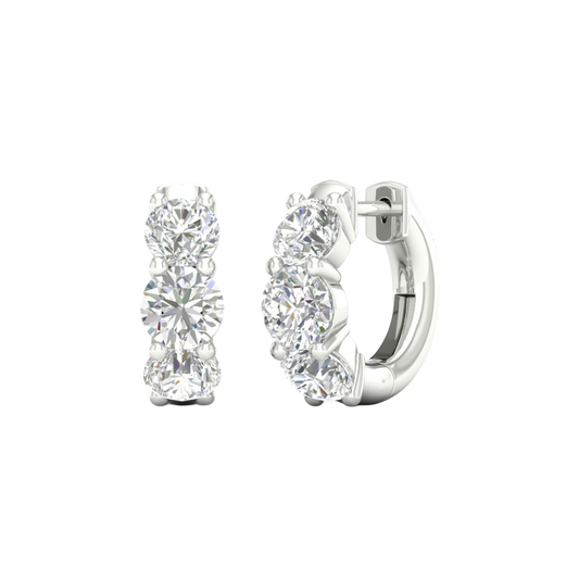 An angled view of a pair of 14K white gold huggie hoops, highlighting the wide, double-row design.