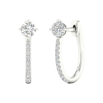 A front and side view of 14K white gold huggie hoops featuring a single top diamond and a pavé diamond drop.