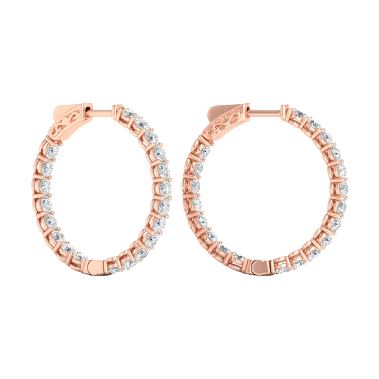 A profile view of 14K rose gold huggie hoop earrings, showing a continuous circle of brilliant, round-cut diamonds on the outer circumference.