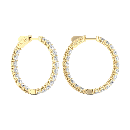 A profile view of 14K yellow gold huggie hoop earrings, showing a continuous circle of brilliant, round-cut diamonds on the outer circumference.