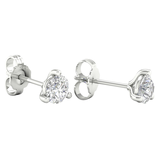 A pair of 14K yellow gold three-prong diamond stud earrings, shown from a side profile.