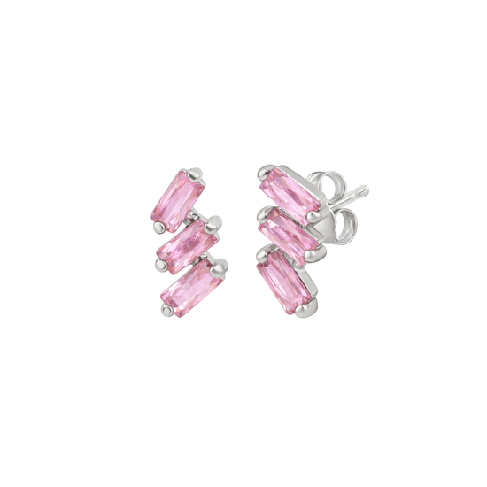 A pair of cascading stud earrings featuring a vertical arrangement of three baguette-cut pink sapphires. The rectangular gemstones are staggered in a step-like formation and held in a minimalist 18k white gold setting, shown against a clean, white studio background.