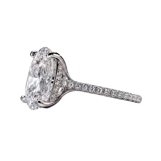 Side profile view of a platinum or white gold engagement ring featuring a large oval-cut diamond with a hidden micro-pavé diamond halo and a pavé-set diamond band.