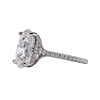 Side profile view of a platinum or white gold engagement ring featuring a large oval-cut diamond with a hidden micro-pavé diamond halo and a pavé-set diamond band.