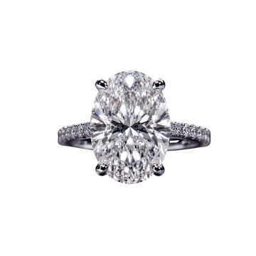 Top-down view of a classic white gold or platinum engagement ring featuring a large brilliant oval-cut center diamond on a sparkling micro-pavé diamond band.
