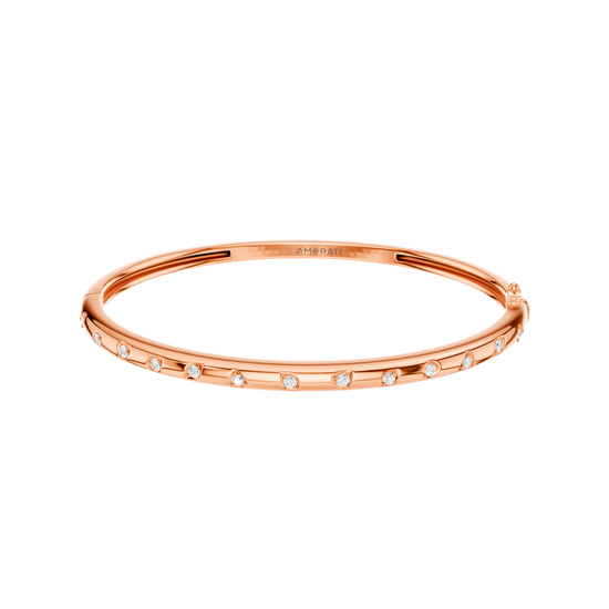 A substantial, high-polish 14k rose gold wide cuff from the Amorati Fourteen Collection, featuring scattered star and geometric insets with shimmering round lab-grown diamonds.