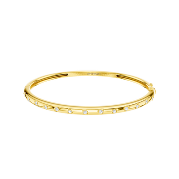 A substantial, high-polish 14k yellow gold wide cuff from the Amorati Fourteen Collection, featuring scattered star and geometric insets with shimmering round lab-grown diamonds.