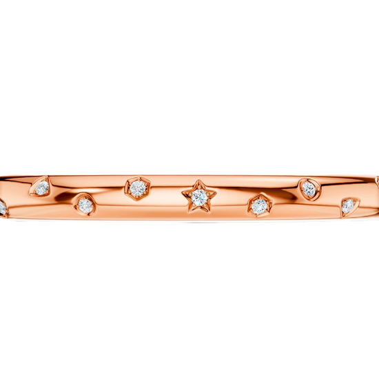 A bold, high-polish 14k rose gold statement bangle by Amorati featuring scattered star and geometric insets with shimmering round-cut lab-grown diamonds. Amorati’s signature F O U R T E E N T H Collection