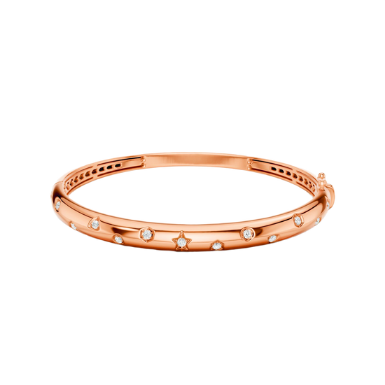 A bold, high-polish 14k rose gold statement bangle by Amorati featuring scattered star and geometric insets with shimmering round-cut lab-grown diamonds. Amorati’s signature F O U R T E E N T H Collection