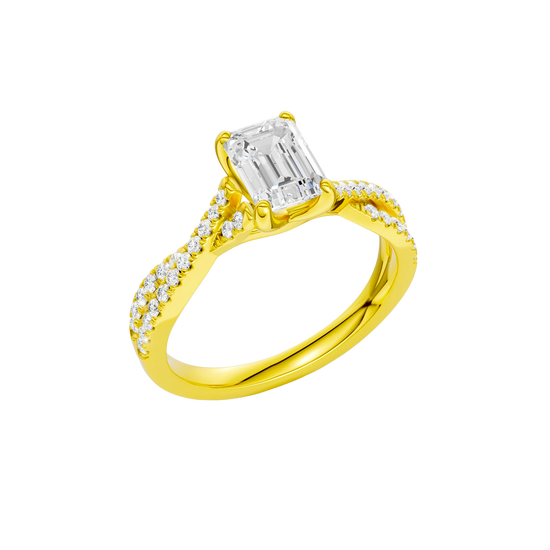 An angled view of 14K yellow gold Amorati Vignette emerald diamond solitaire with prong setting and diamond band