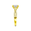 A side view of 14K yellow gold Amorati Vignette emerald diamond solitaire with prong setting and diamond band