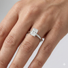 Radiant cut diamond engagement ring in 14k white gold with a plain band and solitaire setting on a hand
