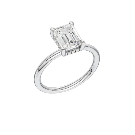 A three-quarter view of the Emerald cut diamond engagement ring in platinum with a plain band and solitaire setting