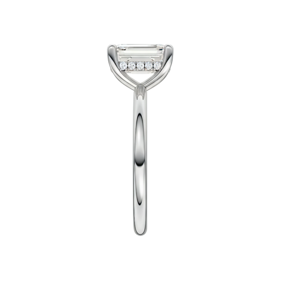 A side view of the Emerald cut diamond engagement ring in 14k white gold with a plain band and solitaire setting