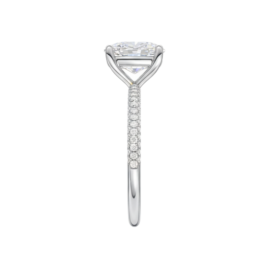 A side view of the Elongated Cushion cut diamond engagement ring in platinum with a pavé diamond band and cathedral setting