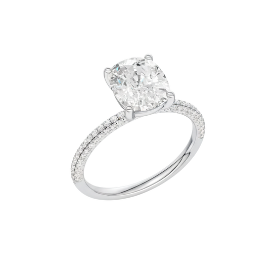 A profile view of the Elongated Cushion cut diamond engagement ring in platinum with a pavé diamond band and cathedral setting