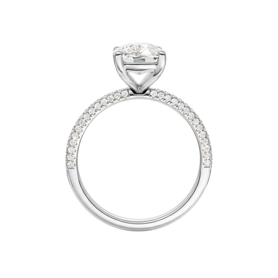 A three-quarter view of the Elongated Cushion cut diamond engagement ring in platinum with a pavé diamond band and cathedral setting