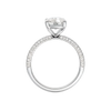 A three-quarter view of the Elongated Cushion cut diamond engagement ring in platinum with a pavé diamond band and cathedral setting