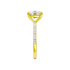A side view of the Elongated Cushion cut diamond engagement ring in 14k yellow gold with a pavé diamond band and cathedral setting