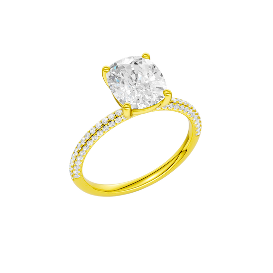 A three-quarter view of the Elongated Cushion cut diamond engagement ring in 14k yellow gold with a pavé diamond band and cathedral setting
