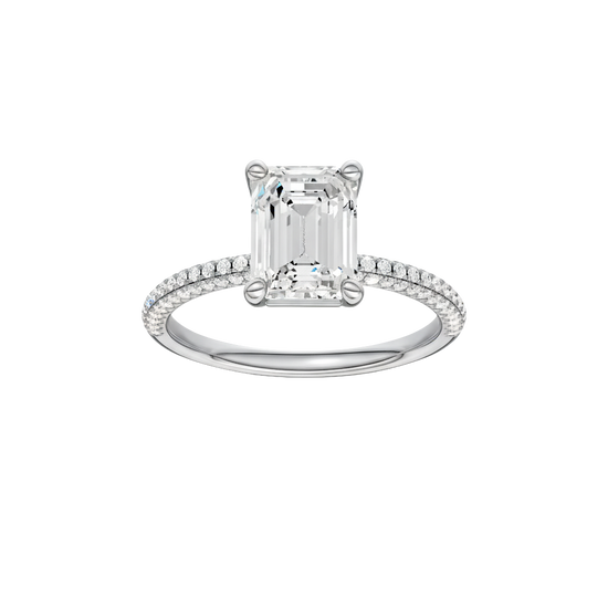 A front view of the Emerald cut diamond engagement ring in platinum with a pavé diamond band and cathedral setting
