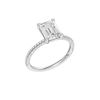 A three-quarter view of the Emerald cut diamond engagement ring in platinum with a pavé diamond band and cathedral setting