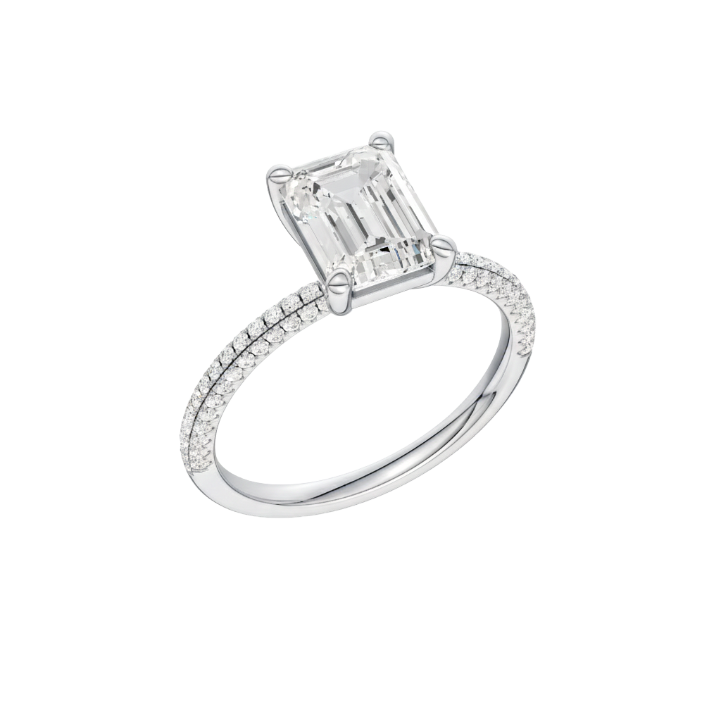 A three-quarter view of the Emerald cut diamond engagement ring in 14k white gold with a pavé diamond band and cathedral setting